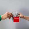 Two hands exchange an art volunteering flyer, emphasizing community and creativity.
